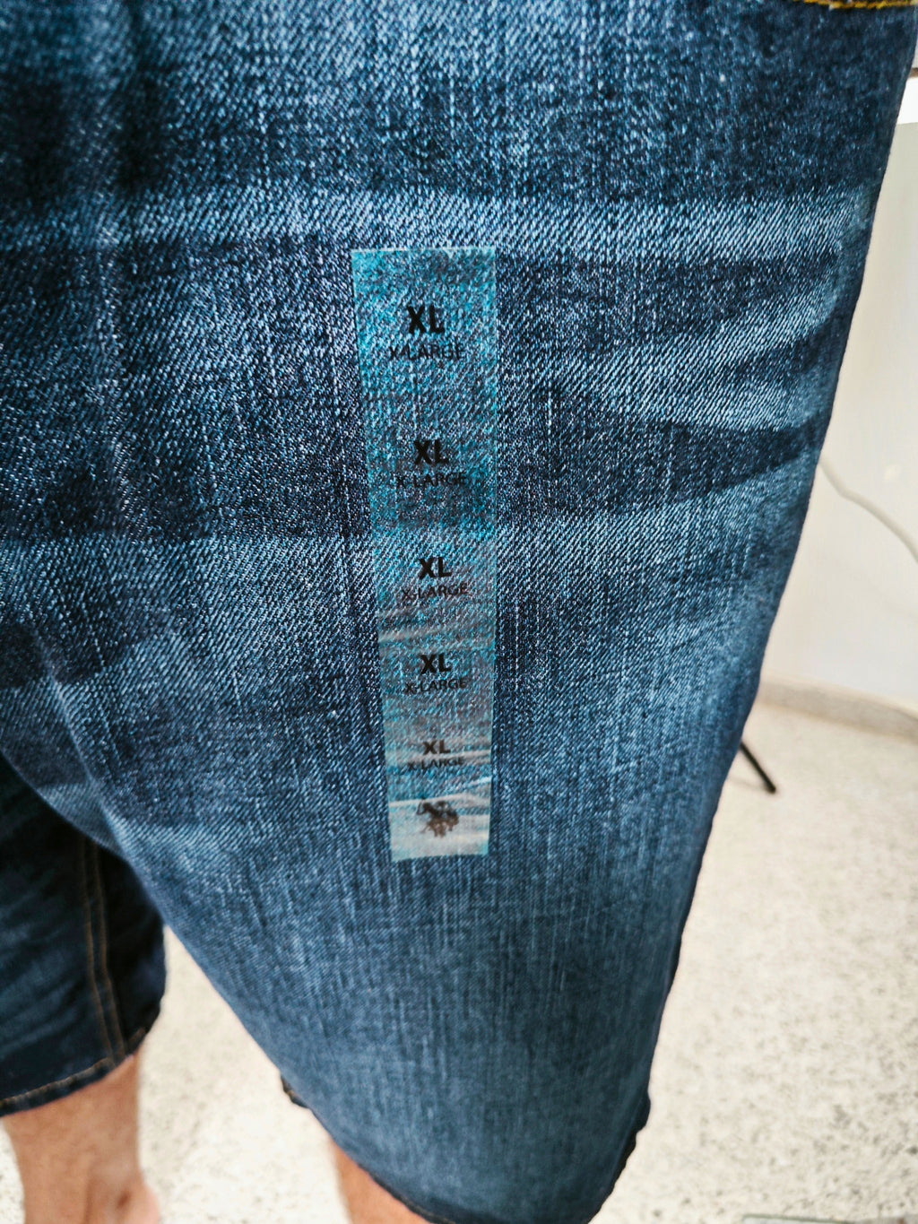 Detalle del tejido denim azul oscuro de bermudas ECKO UNLTD con efecto lavado y costuras en contraste.